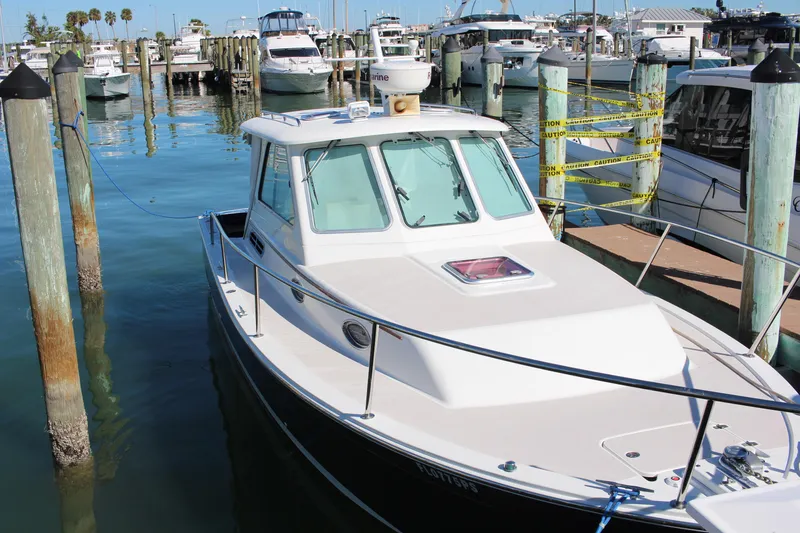 Slide: The Image of 2007 Back Cove 29 boat docked in a marina with other vessels. - 2
