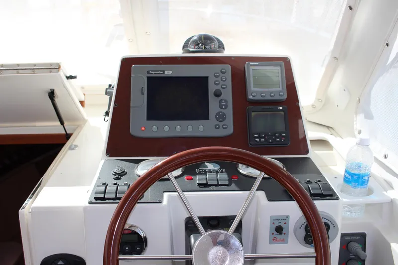 Slide: The Image of 2007 Back Cove 29 boat helm with navigation equipment and steering wheel. - 3