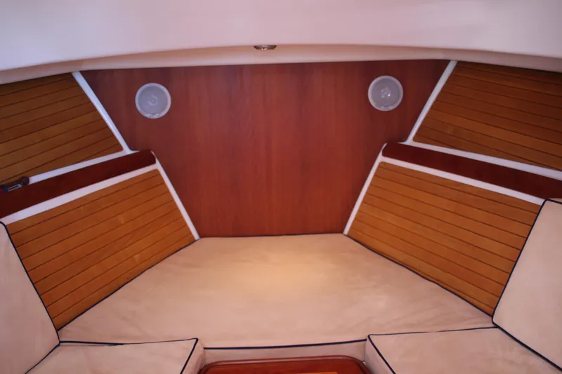 Slide: The Image of 2007 Back Cove 29 interior cabin with wood paneling and beige cushions. - 4