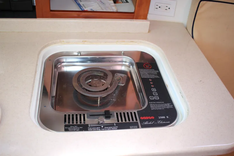 Slide: The Image of Electric stove on 2007 Back Cove 29 boat, featuring a single coil burner. - 8