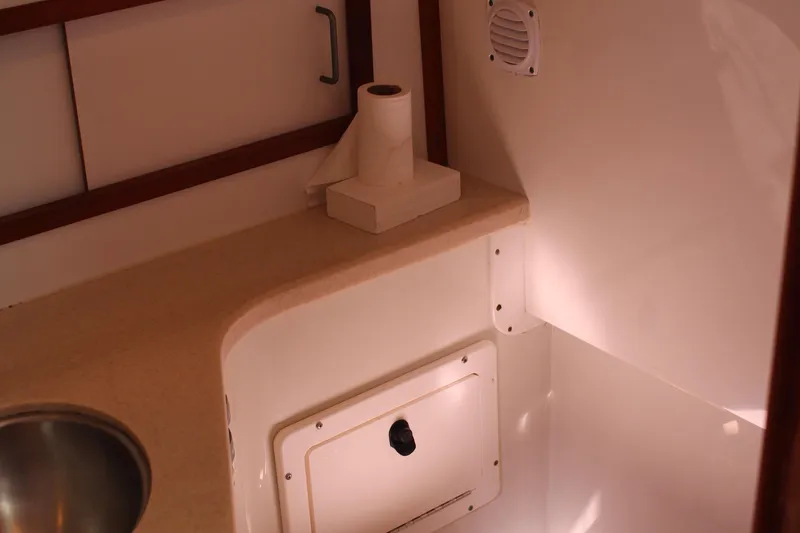 Slide: The Image of 2007 Back Cove 29 interior with countertop, sink, and storage compartment. - 9