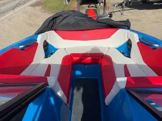 Slide: The Image of 2023 MasterCraft NXT22 boat interior with red and white seating, blue accents. - 4