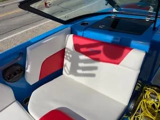 Slide: The Image of 2023 MasterCraft NXT22 boat interior with red and white seating, blue accents. - 7