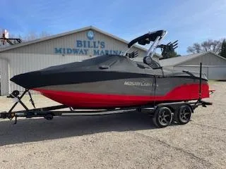 Slide: The Image of 2024 MasterCraft NXT22 boat in red and black at Bill's Midway Marina. - 2