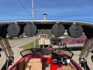 Slide: The Image of 2024 MasterCraft NXT22 boat interior with speakers and steering wheel, parked outdoors. - 3