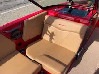 Slide: The Image of 2024 MasterCraft NXT22 boat interior with tan seats and red accents. - 5