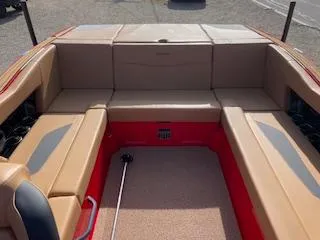Slide: The Image of 2024 MasterCraft NXT22 boat interior with tan seating and red accents. - 7
