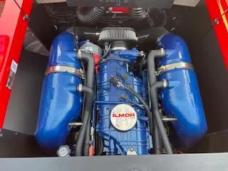 Slide: The Image of 2024 MasterCraft NXT22 Ilmor engine with blue components in a boat. - 8
