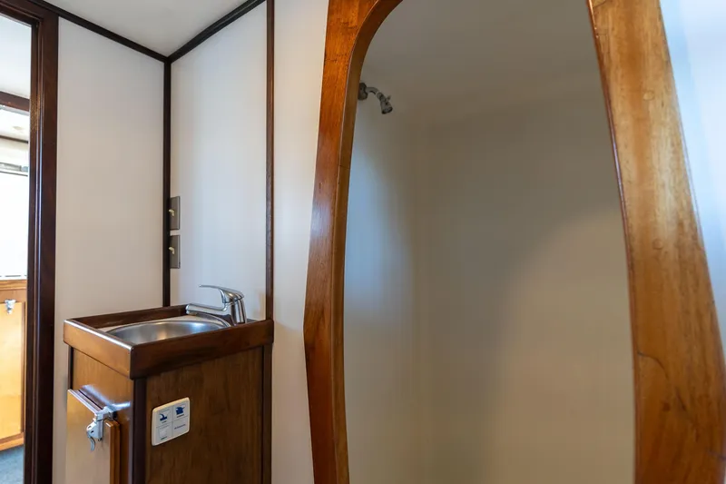 Slide: The Image of 1980 Commercial Troller interior with wooden sink and shower area. - 13