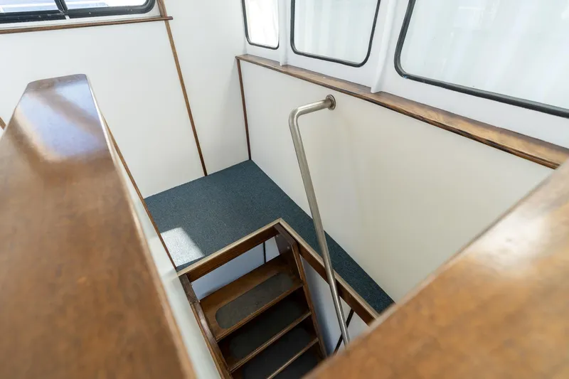 Slide: The Image of Interior view of a 1980 Commercial Troller boat staircase with wooden accents. - 18