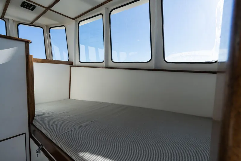 Slide: The Image of Interior of 1980 Commercial Troller boat with cushioned seating and large windows. - 20