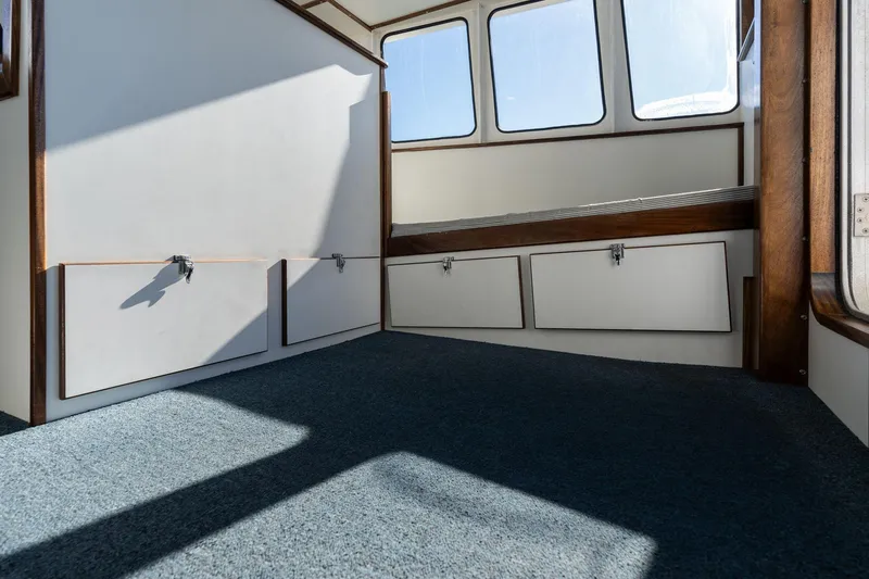 Slide: The Image of Interior of a 1980 Commercial Troller boat with carpeted floor and storage compartments. - 21