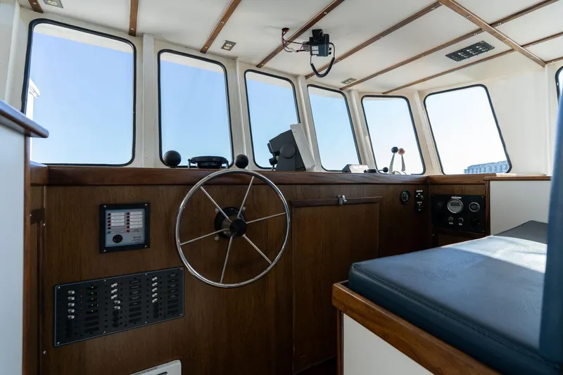 Slide: The Image of 1980 Commercial Troller interior with steering wheel, control panel, and large windows. - 22