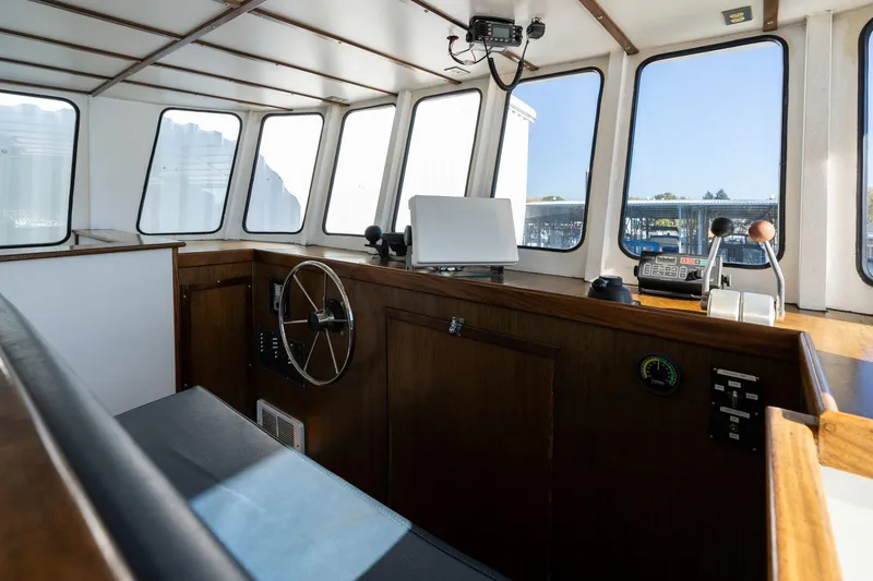 Slide: The Image of 1980 Commercial Troller interior with steering wheel and navigation equipment. - 23