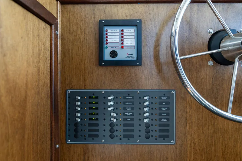 Slide: The Image of 1980 Commercial Troller control panel with steering wheel and electrical switches. - 28