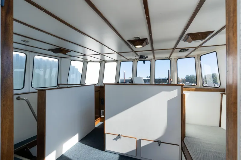 Slide: The Image of Interior of a 1980 Commercial Troller boat with wooden accents and large windows. - 32