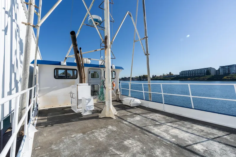 Slide: The Image of Commercial troller boat deck, 1980 model, with clear blue sky and waterfront view. - 35