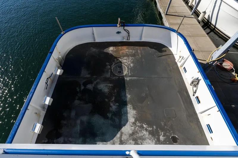 Slide: The Image of 1980 Commercial Troller deck, spacious and clean, docked by the water. - 36