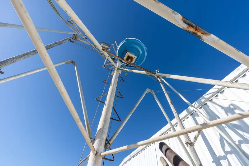Slide: The Image of Rusted metal structure with blue sky background, featuring a 1980 Commercial Troller model. - 39