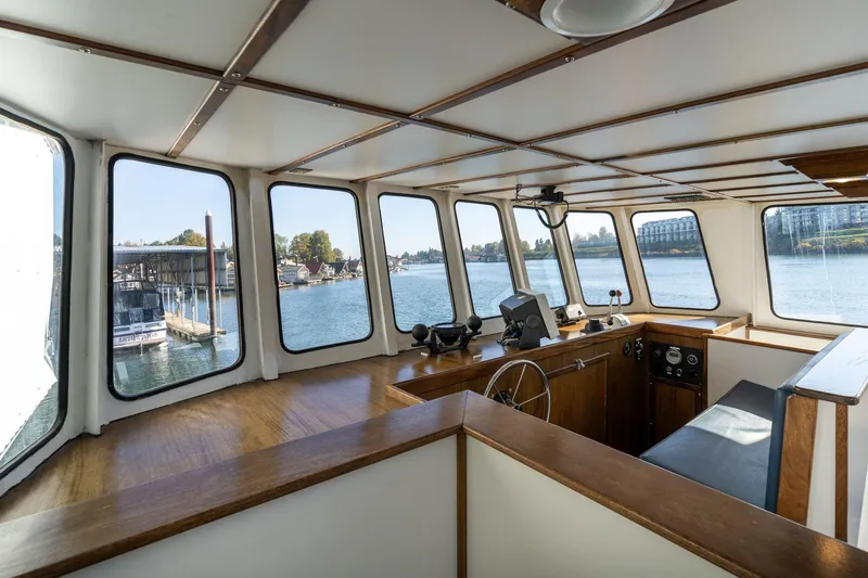Slide: The Image of Interior view of a 1980 Commercial Troller boat with large windows overlooking the water. - 41