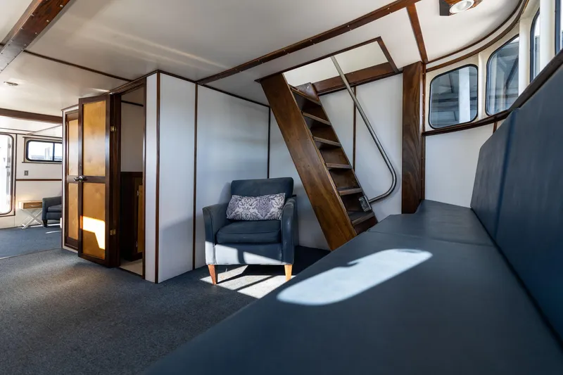 Slide: The Image of Interior of 1980 Commercial Troller with seating, stairs, and wood accents. - 43