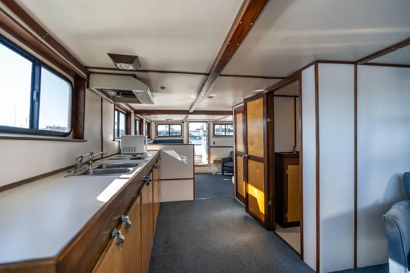 Slide: The Image of Interior of a 1980 Commercial Troller boat with kitchen and seating area. - 44