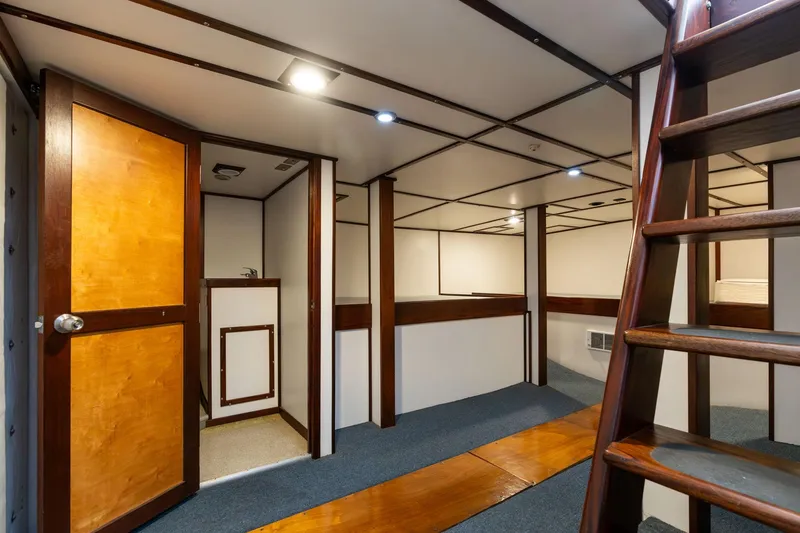 Slide: The Image of 1980 Commercial Troller interior with wooden accents and ladder, featuring modern lighting. - 47