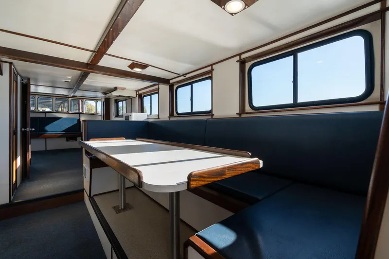 Slide: The Image of Interior of a 1980 Commercial Troller boat with seating and windows. - 5