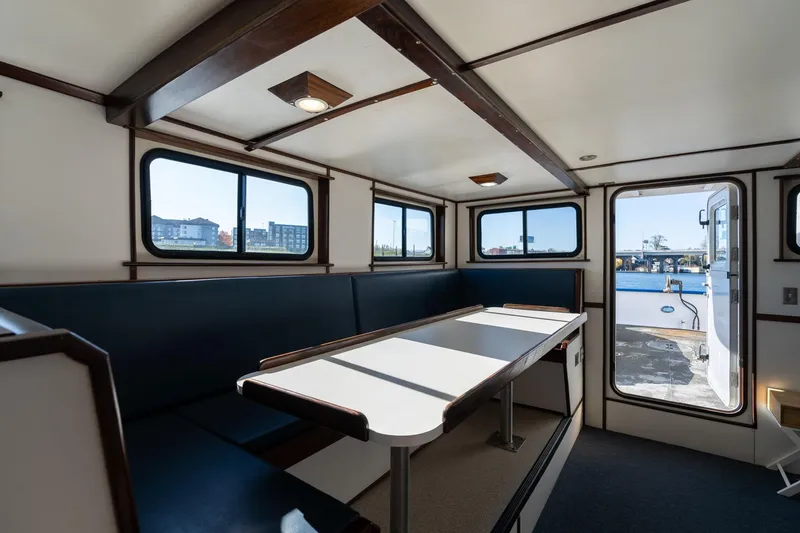 Slide: The Image of Interior of a 1980 Commercial Troller boat with seating and windows. - 6