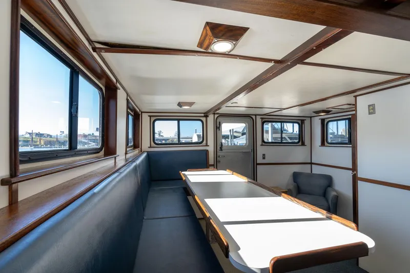 Slide: The Image of Interior of a 1980 Commercial Troller boat with seating and table. - 7