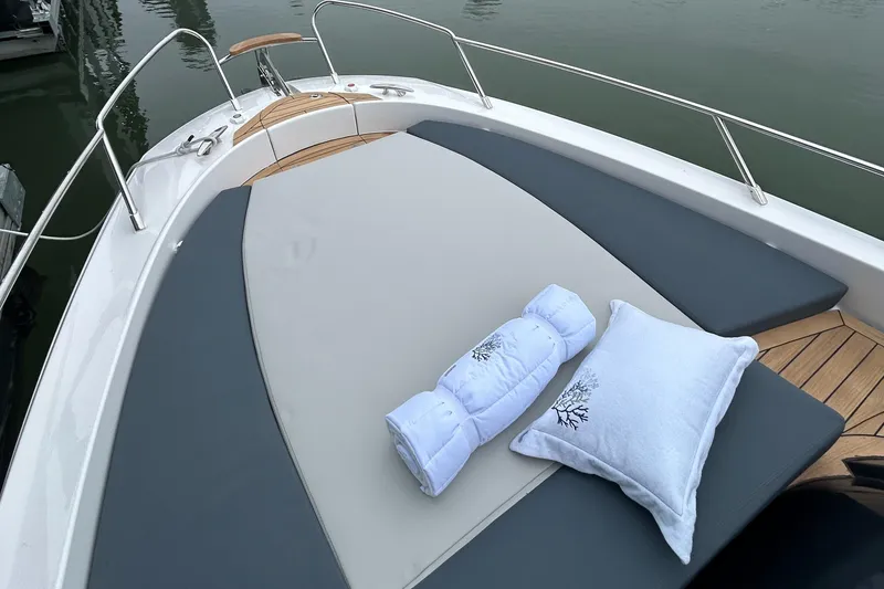 Slide: The Image of 2024 Sessa Marine Key Largo 27 Outboard Line boat with cushioned deck and pillows. - 10