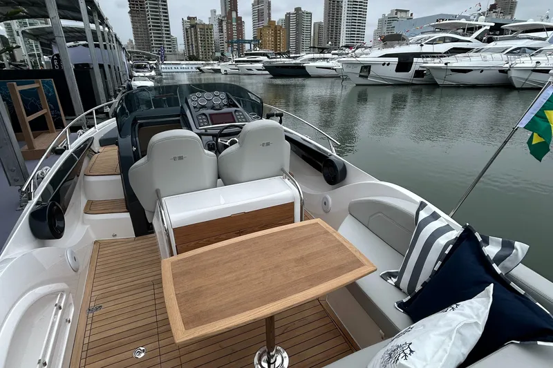Slide: The Image of 2024 Sessa Marine Key Largo 27 boat interior with city skyline and marina view. - 13