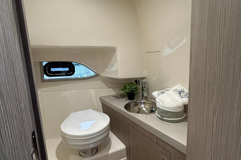 Slide: The Image of 2024 Sessa Marine Key Largo 27 bathroom with modern fixtures and compact design. - 16