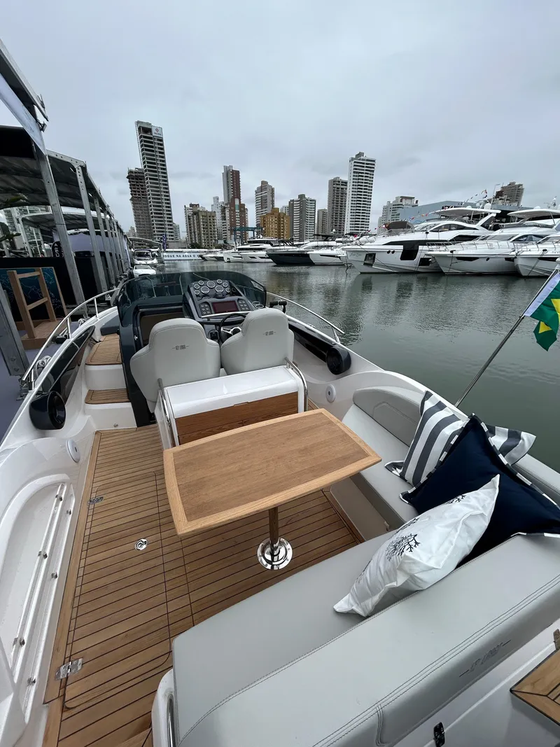 Slide: The Image of 2024 Sessa Marine Key Largo 27 Outboard Line in a marina with city skyline. - 4