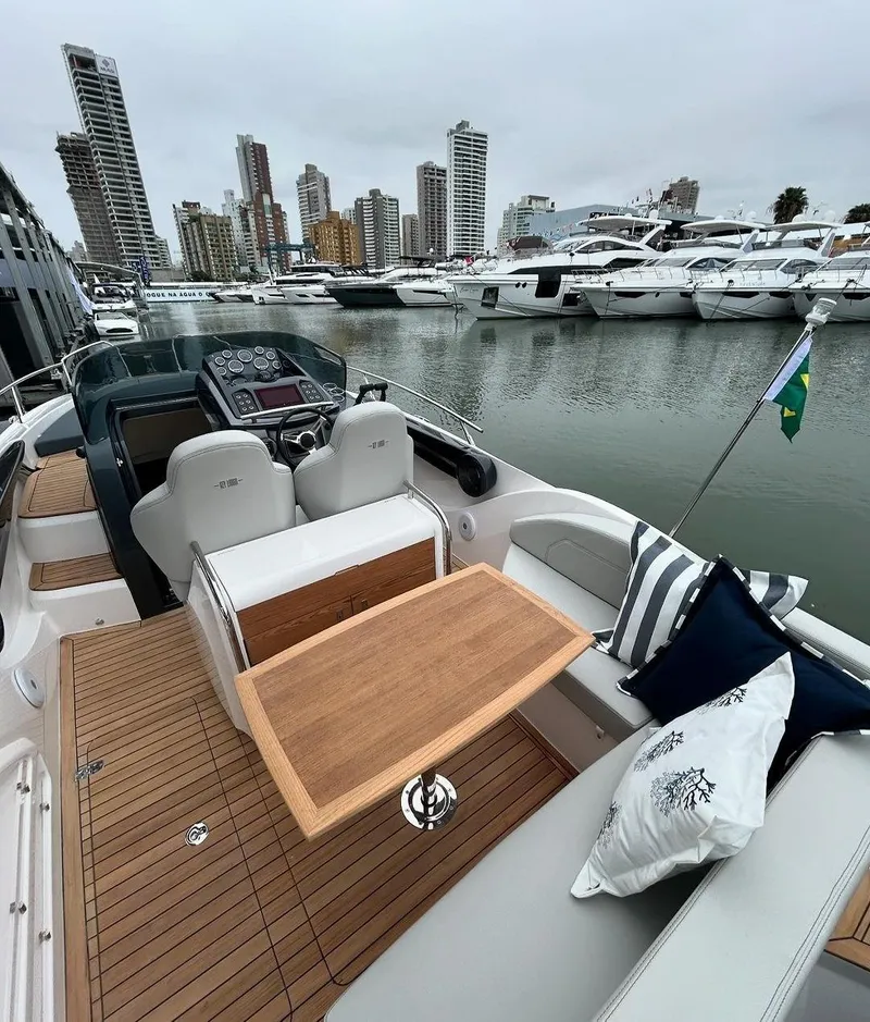Slide: The Image of 2024 Sessa Marine Key Largo 27 boat with elegant deck, docked in a marina. - 5