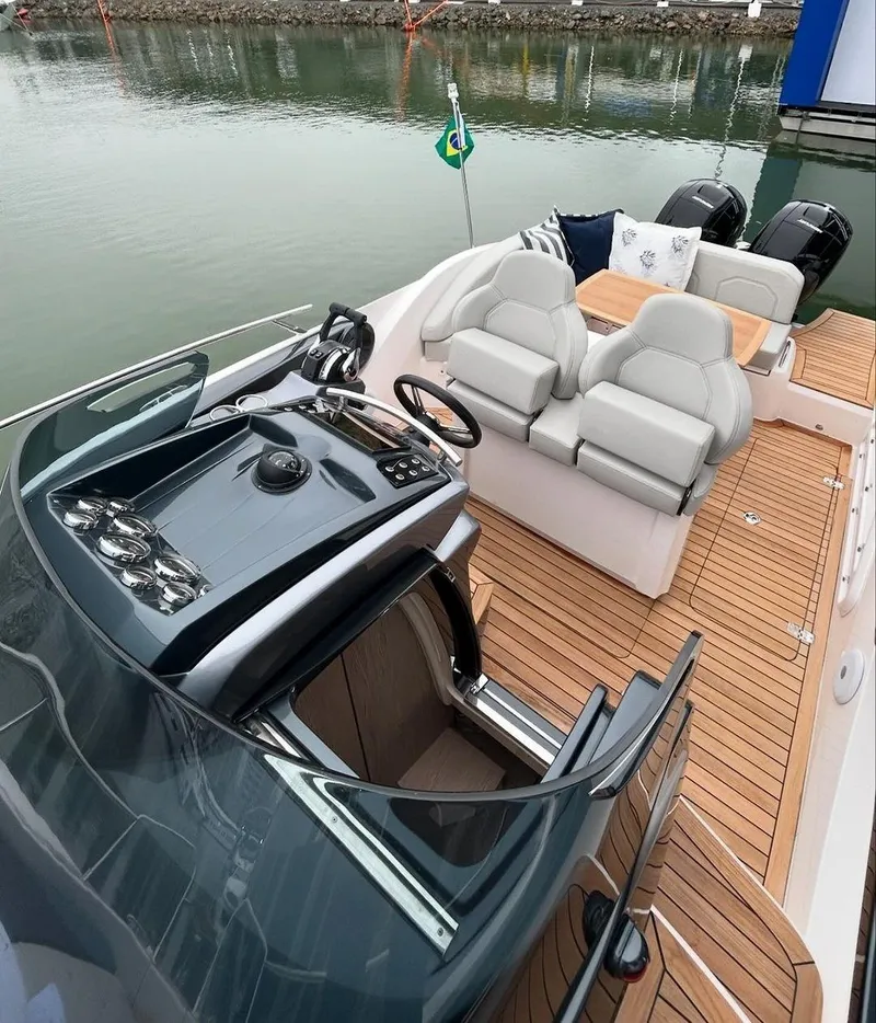 Slide: The Image of 2024 Sessa Marine Key Largo 27 Outboard, luxury boat interior with dual seating and wooden deck. - 6