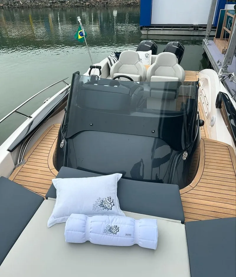 Slide: The Image of 2024 Sessa Marine Key Largo 27 Outboard, luxury boat interior with cushions, docked by water. - 7