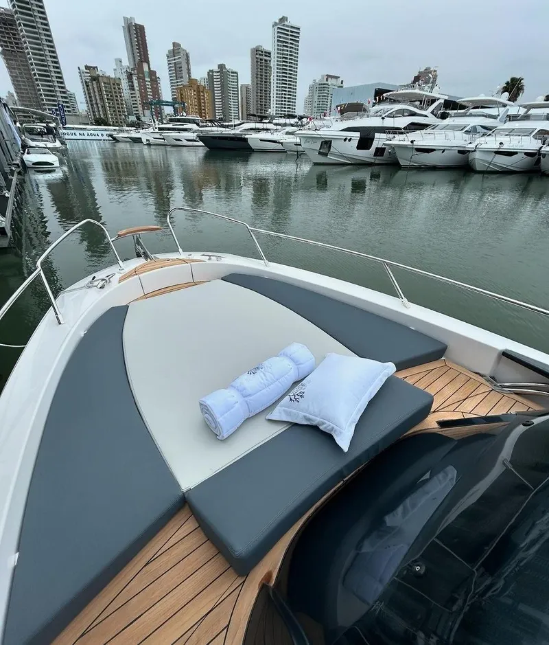 Slide: The Image of 2024 Sessa Marine Key Largo 27 at marina with city skyline backdrop. - 9