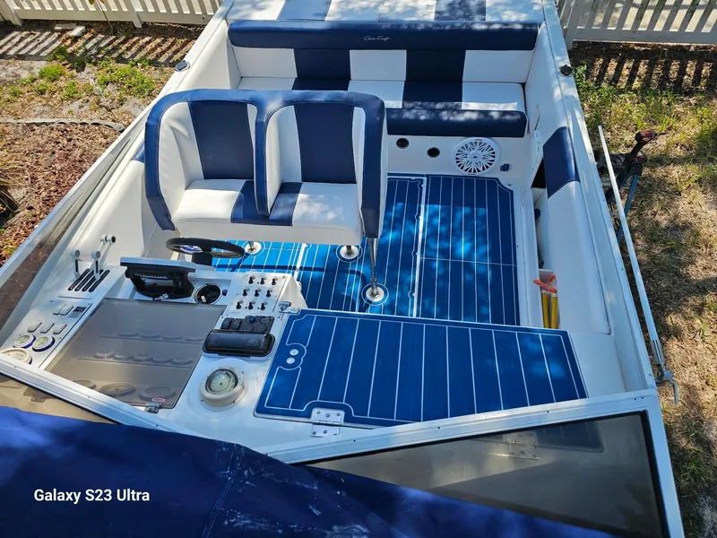 Slide: The Image of 1983 Chris-Craft 312 SL boat interior with blue and white seating and flooring. - 12
