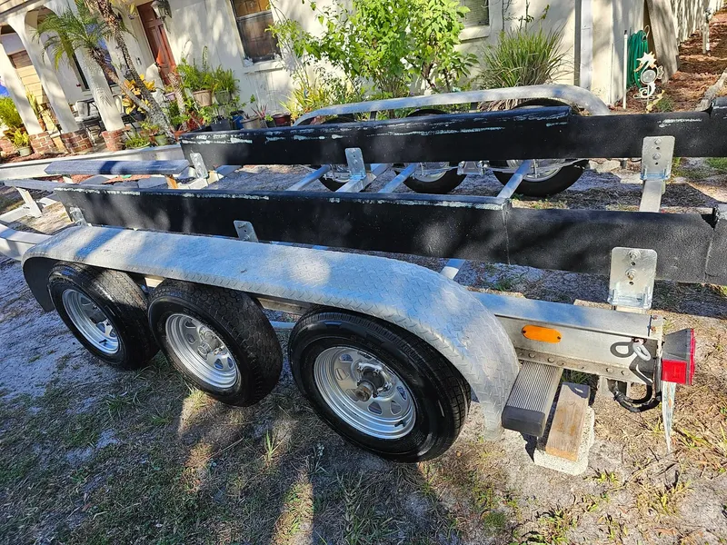 Slide: The Image of Triple-axle boat trailer for 1983 Chris-Craft 312 SL, parked outdoors. - 13