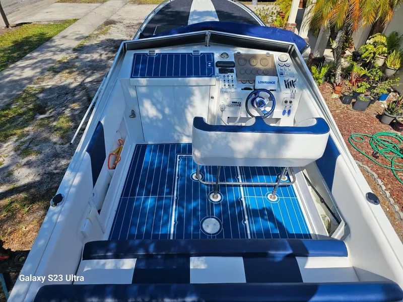 Slide: The Image of 1983 Chris-Craft 312 SL boat cockpit with blue and white seating and control panel. - 3