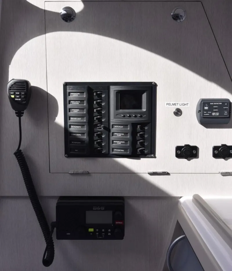 Slide: The Image of Control panel of a 2025 Corsair 970 boat with communication devices and switches. - 3