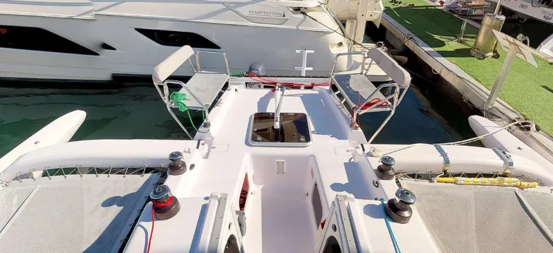 Slide: The Image of 2025 Corsair 970 sailboat docked, featuring spacious deck and modern design. - 2