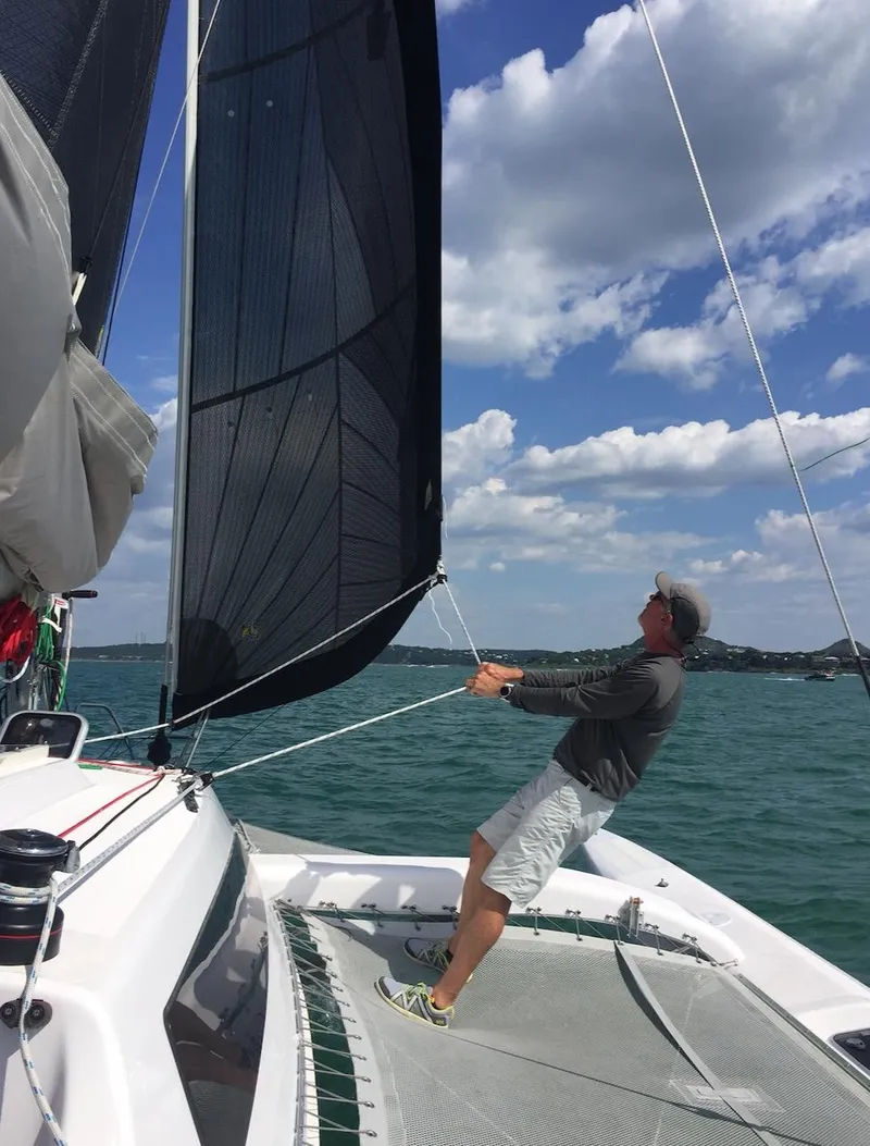 Slide: The Image of Person sailing a 2025 Corsair 970 Sport on a sunny day. - 9