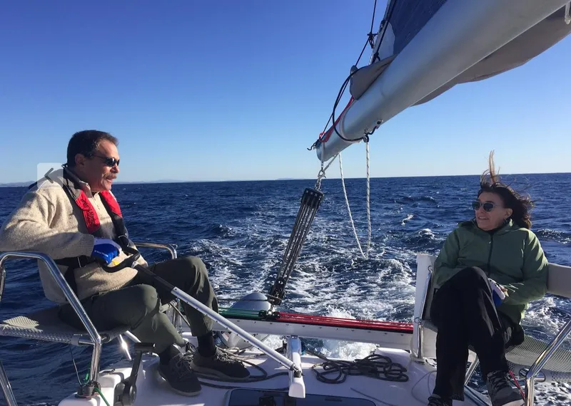 Slide: The Image of Two people sailing on a 2025 Corsair 970 Sport in open sea. - 6