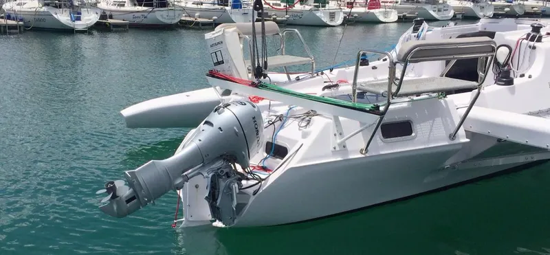 Slide: The Image of 2025 Corsair 970 Sport boat docked in marina, featuring sleek design and powerful outboard motor. - 7