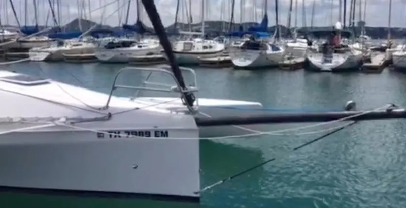 Slide: The Image of Corsair 970 Sport 2025 sailboat docked in marina with other boats in background. - 8