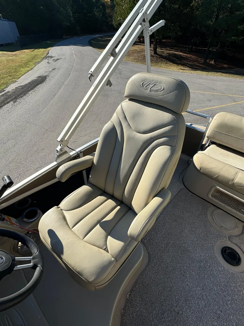 Slide: The Image of Captain's chair on 2011 Harris 250GMSE boat, beige upholstery, sunny day. - 11