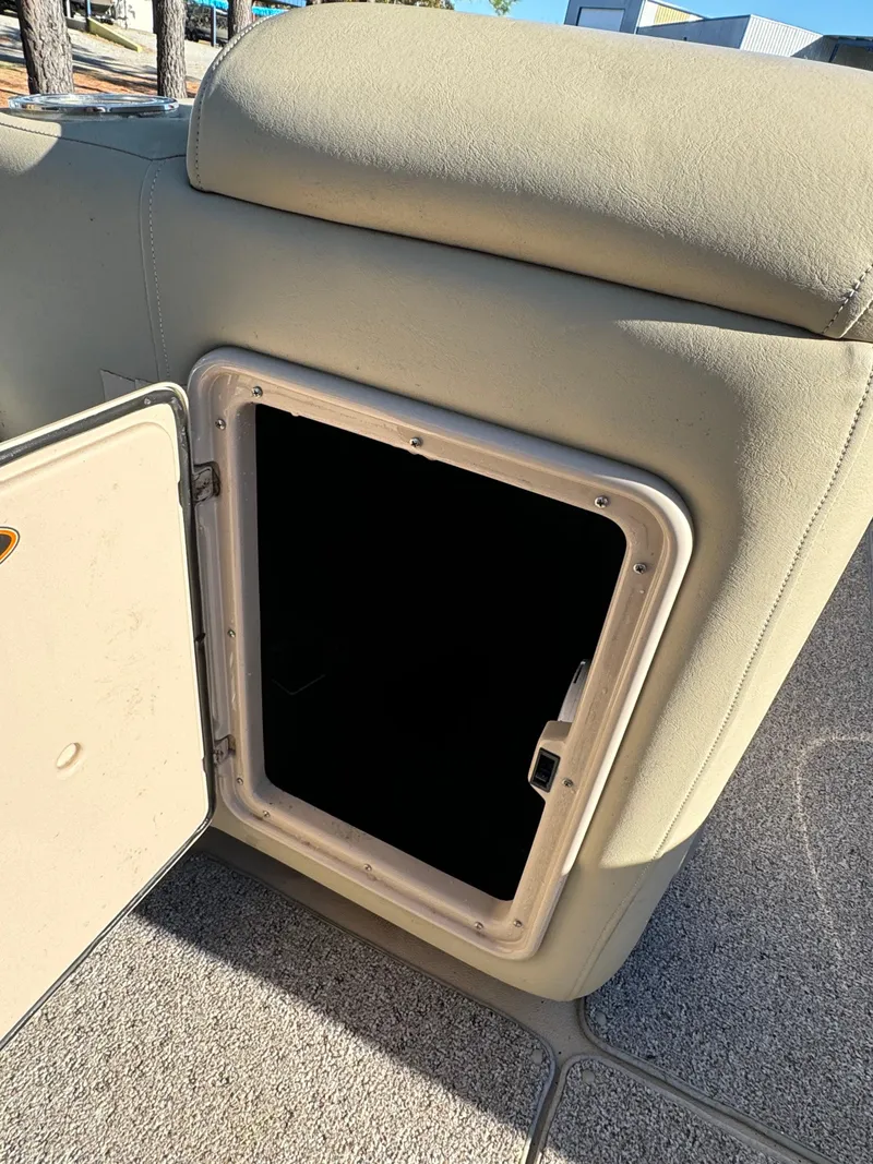 Slide: The Image of Open storage compartment on a 2011 Harris 250GMSE boat, beige upholstery. - 13