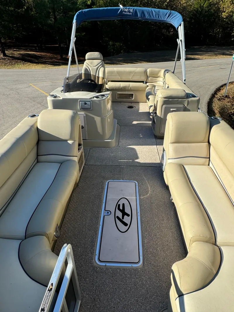 Slide: The Image of 2011 Harris 250GMSE pontoon boat with beige seating and blue canopy. - 3